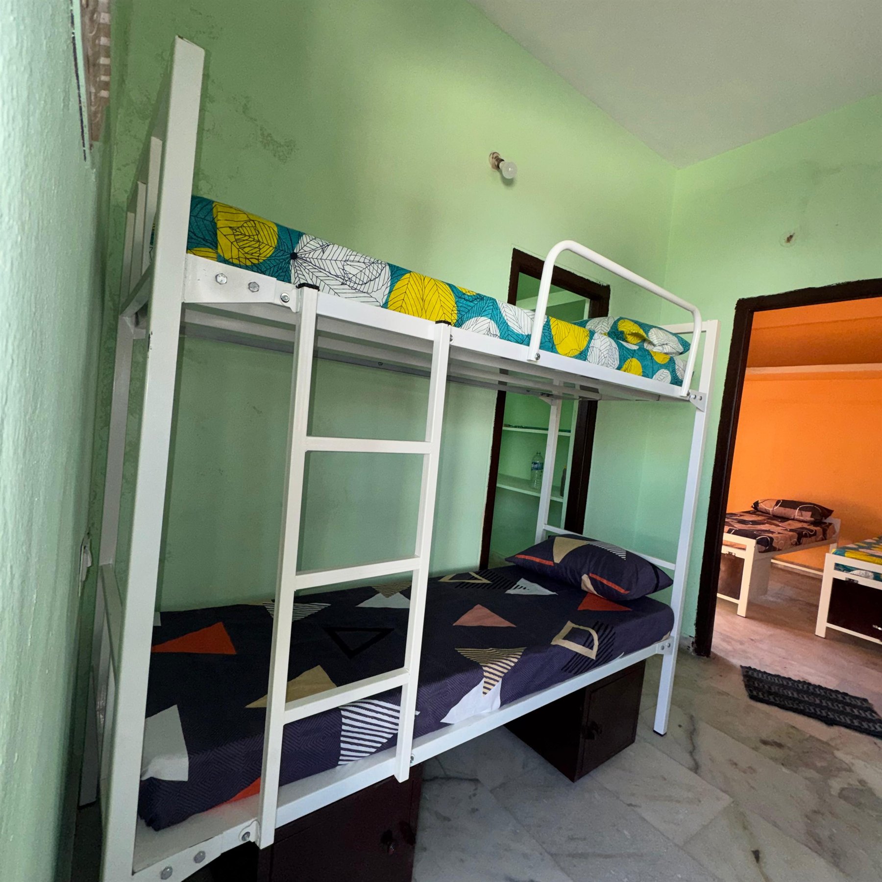 Boys hostel bunk bed room with bedding and storage