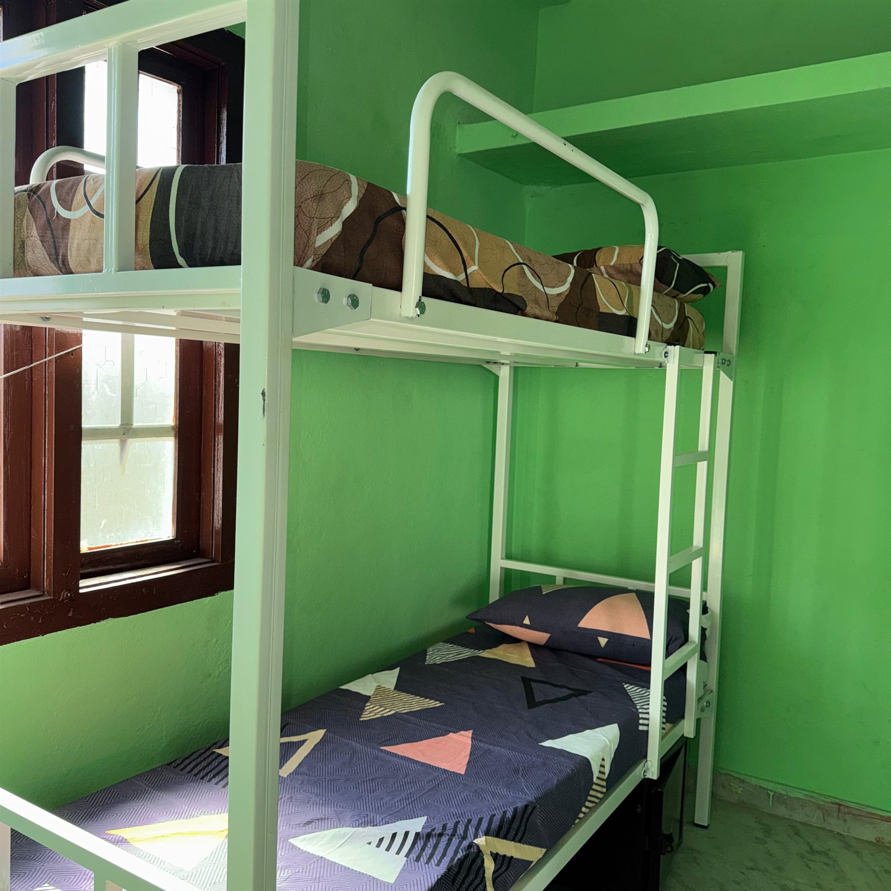 Boys hostel room bed with clean bedding