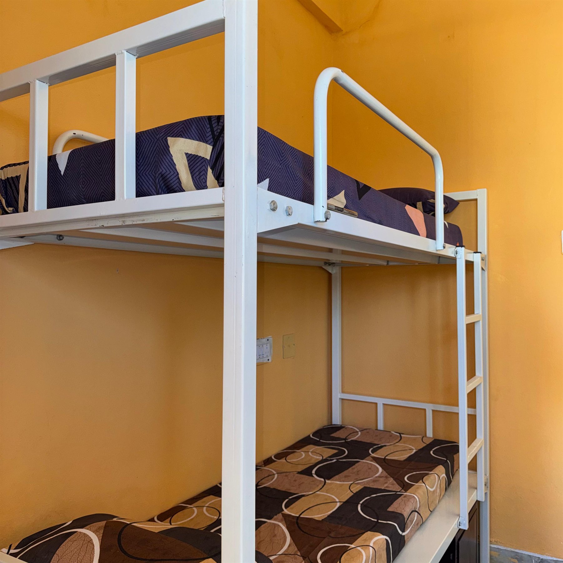 Boys hostel sharing room with bright bedding