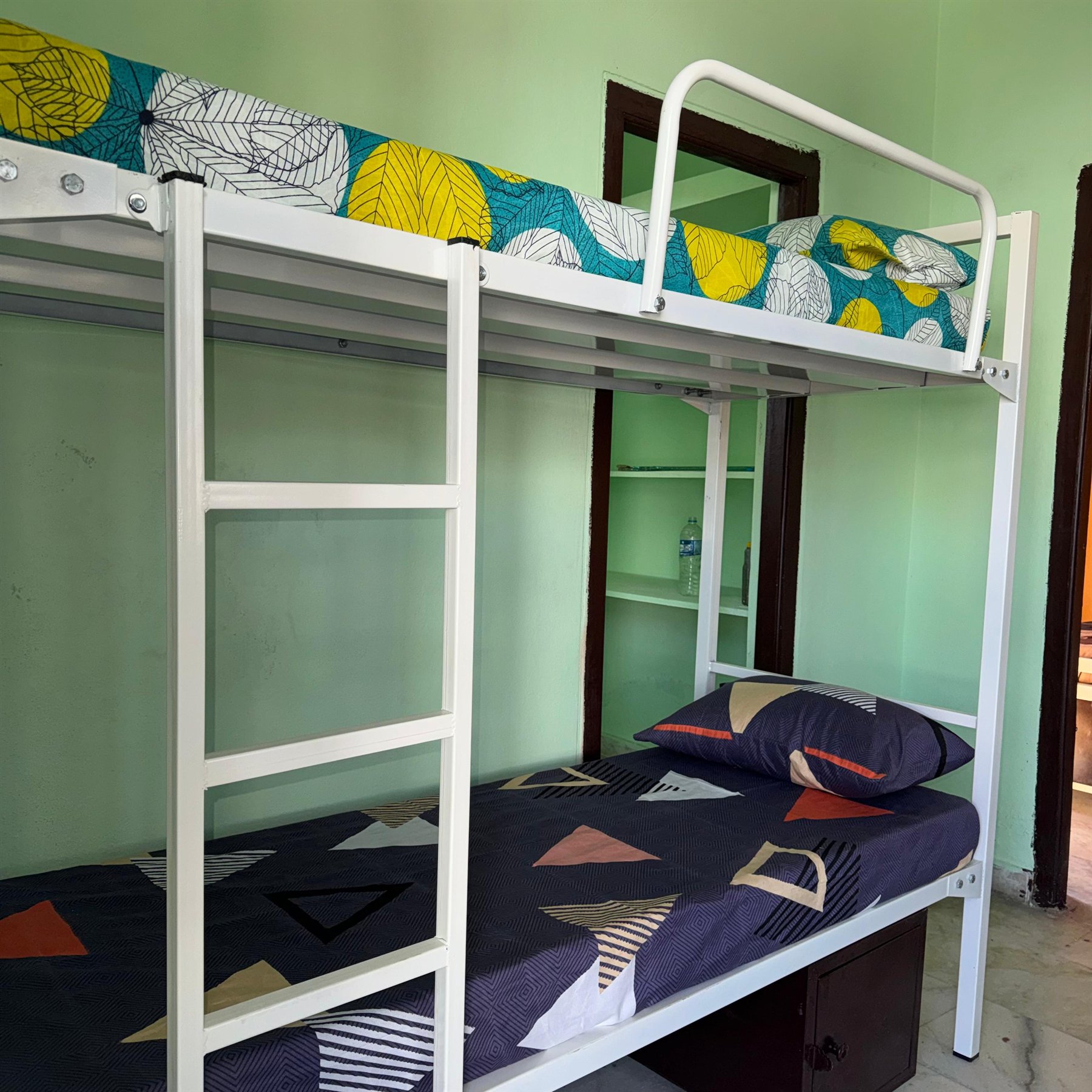 Boys hostel room with bunk bed and shelves