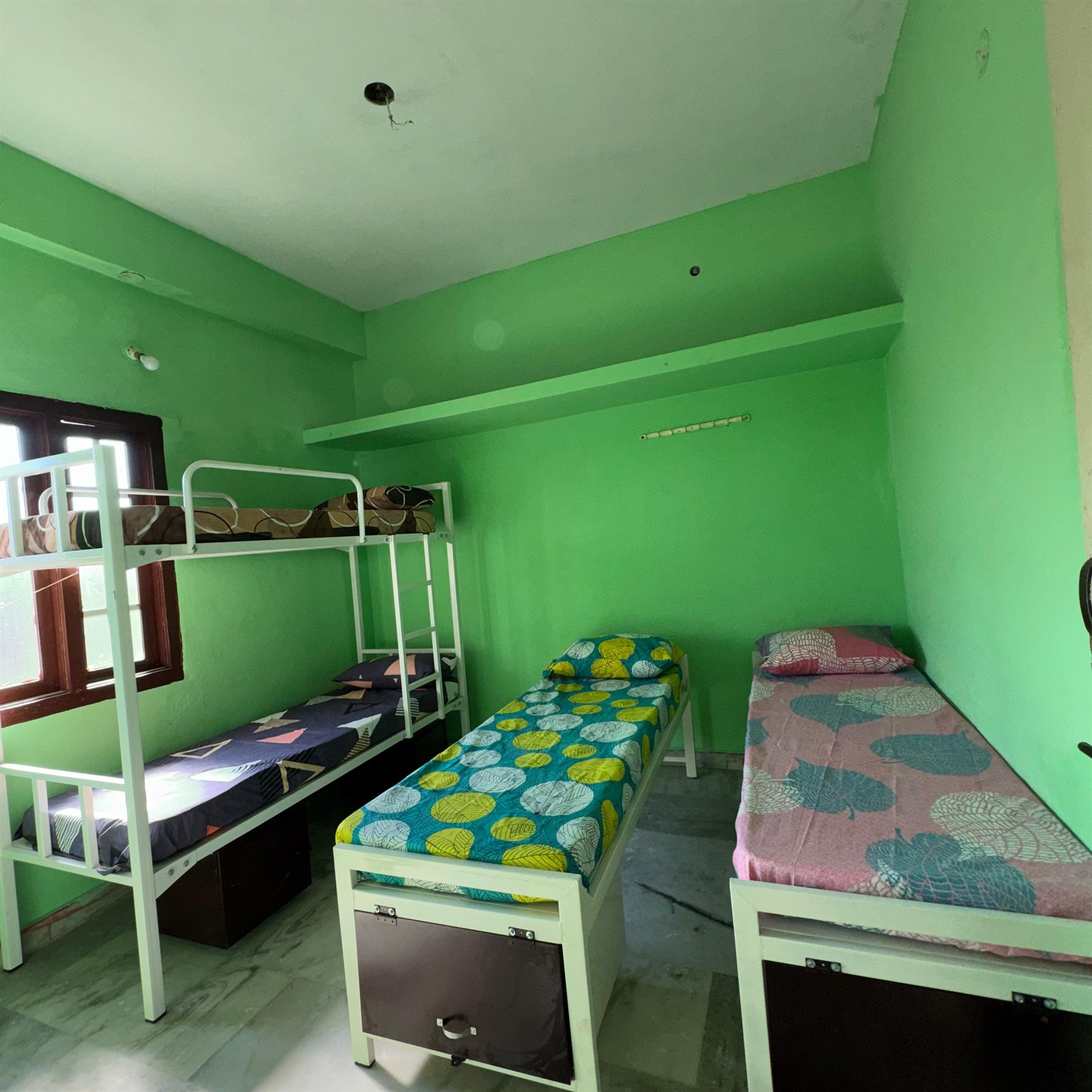 Boys hostel room with neatly arranged beds
