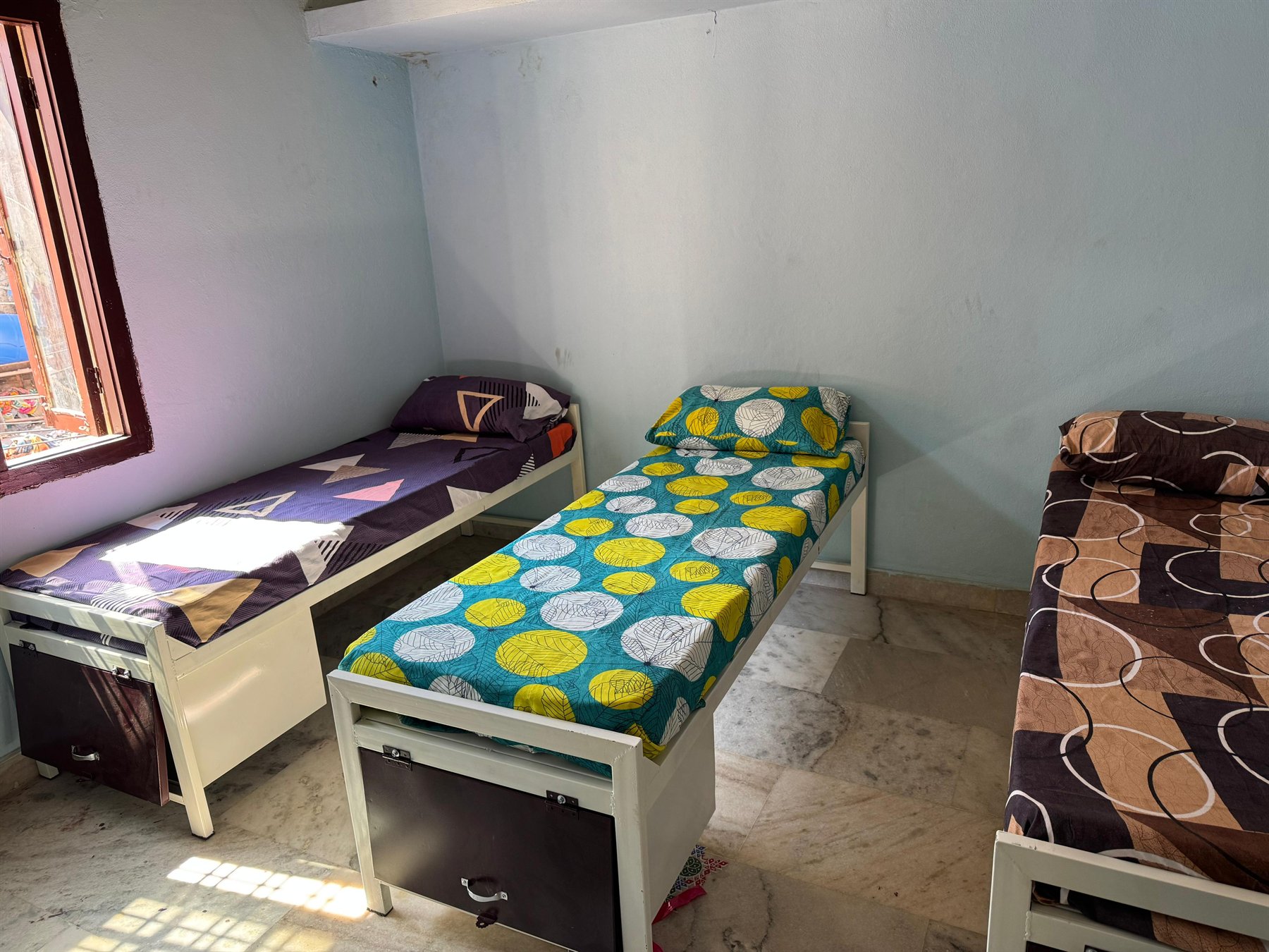 Boys hostel room with beds and storage drawers
