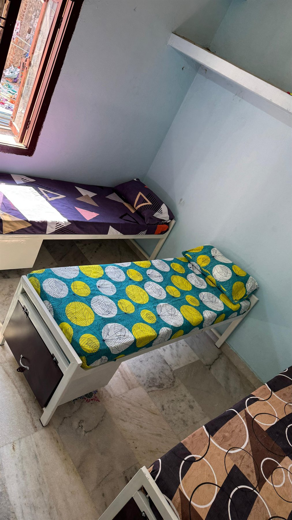 Boys hostel tall room view with neatly kept beds